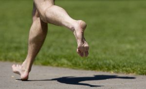 Ryan Whitaker runs barefoot at Esther Short Park, Thursday, May 12, 2011. (Steven Lane/The Columbian)